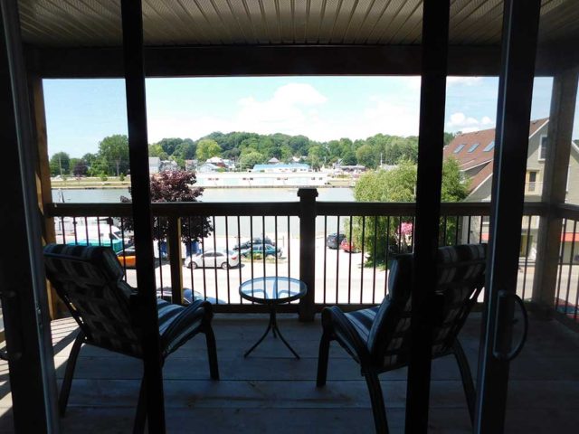 balcony with two chairs and view of river